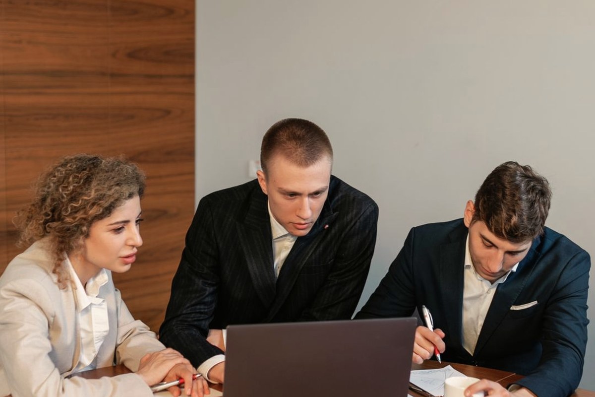 A team checking records on screen